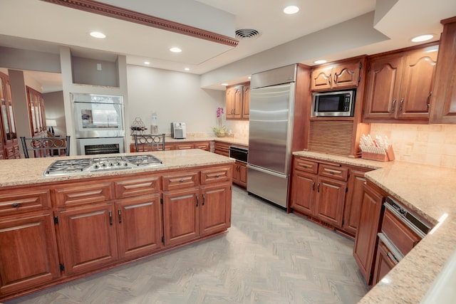 1301 12th Ave NW, New Brighton, MN 55112 - kitchen featuring built in appliances, light stone counters, recessed lighting, a warming drawer, and brown cabinetry