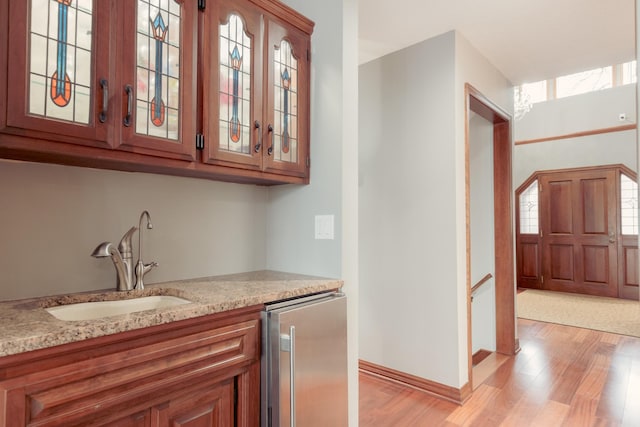 1301 12th Ave NW, New Brighton, MN 55112 - indoor bar featuring stainless steel refrigerator, light wood-style flooring, and baseboards