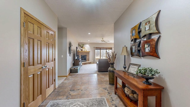 hallway with baseboards and a textured ceiling