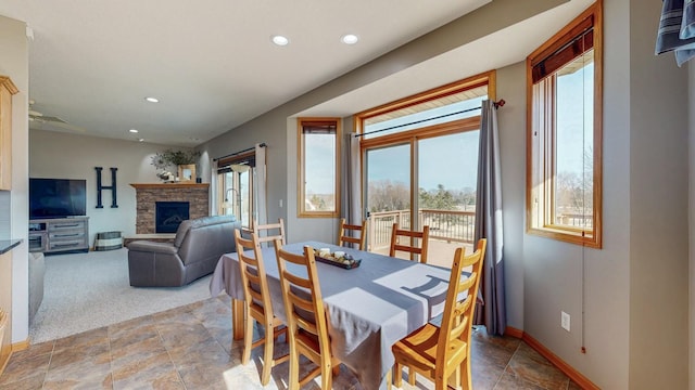 dining area with recessed lighting, baseboards, and a fireplace