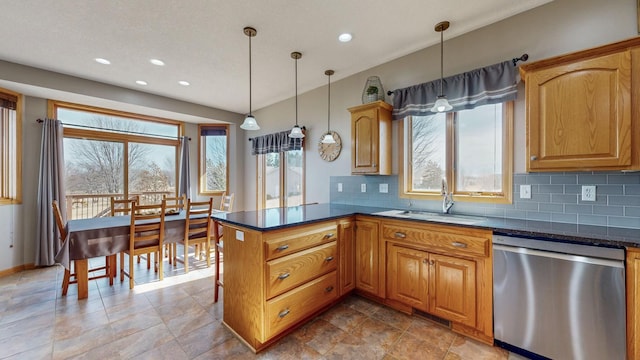 kitchen featuring a wealth of natural light, a sink, a peninsula, decorative backsplash, and dishwasher