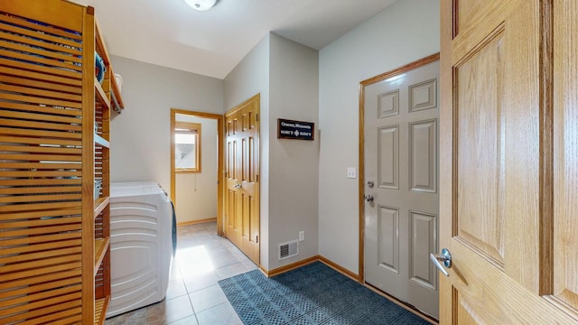 laundry room with tile patterned floors, visible vents, baseboards, and laundry area