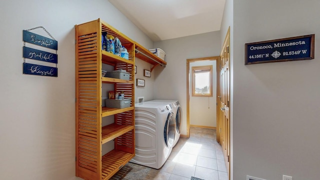 laundry room with light tile patterned floors, laundry area, baseboards, and separate washer and dryer