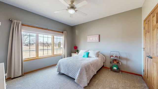 bedroom with light carpet, ceiling fan, and baseboards