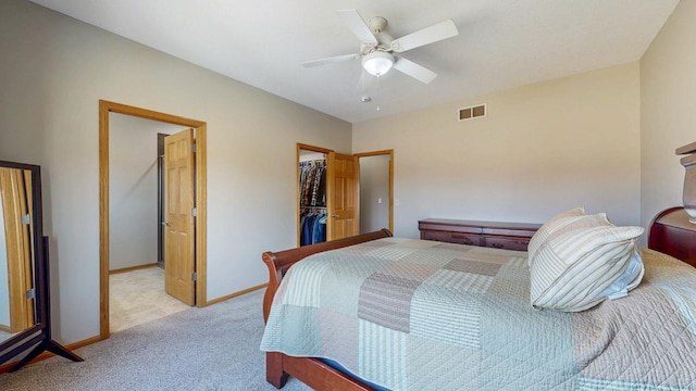 bedroom with visible vents, baseboards, a spacious closet, a closet, and light colored carpet