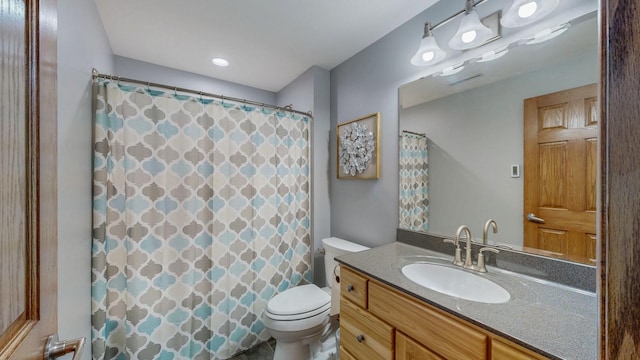 bathroom featuring curtained shower, toilet, and vanity