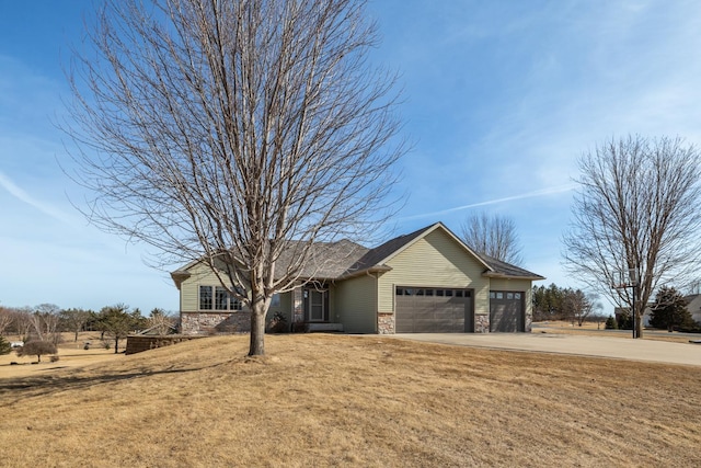 single story home featuring stone siding, driveway, an attached garage, and a front yard