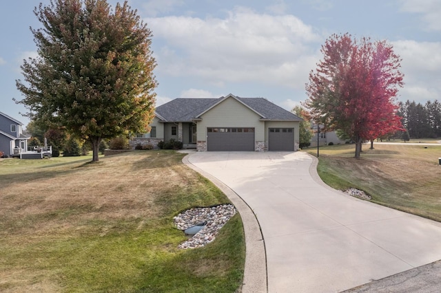 view of front of house with stone siding, a front yard, concrete driveway, and an attached garage