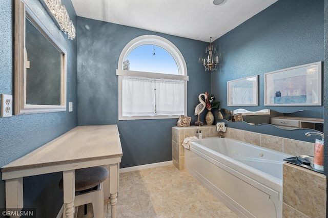 full bath featuring a textured wall, a notable chandelier, baseboards, and a bath