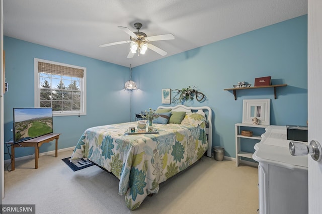 bedroom featuring light carpet, ceiling fan, and baseboards