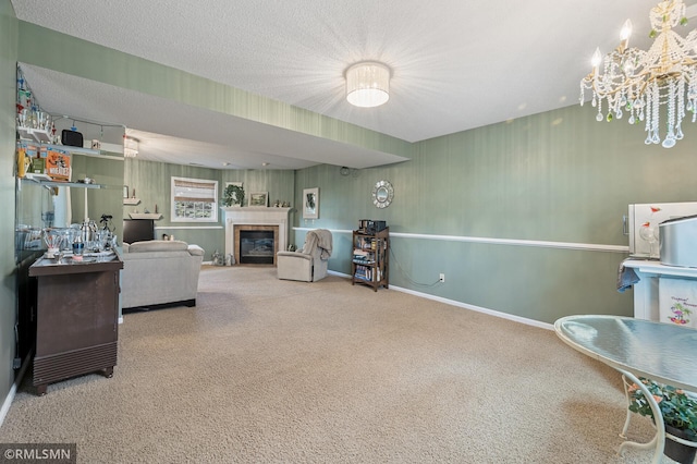 carpeted living area featuring a chandelier, a tile fireplace, a textured ceiling, and baseboards