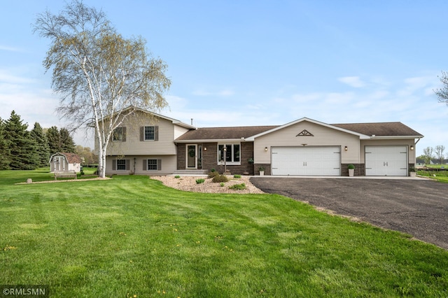 tri-level home featuring an attached garage, driveway, and a front lawn