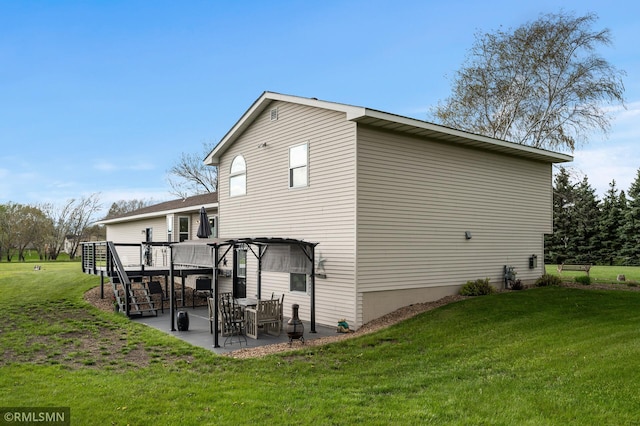back of property featuring a lawn, a deck, a patio area, and stairs