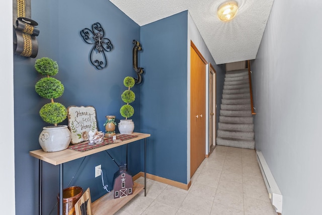 corridor with stairway, baseboards, a textured ceiling, and a baseboard radiator