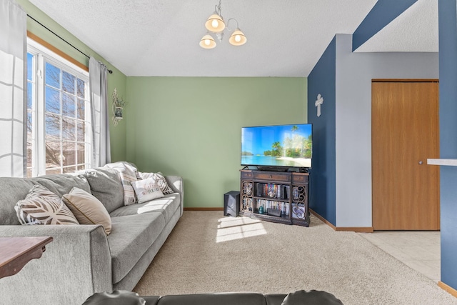 living area featuring baseboards, carpet floors, and a textured ceiling