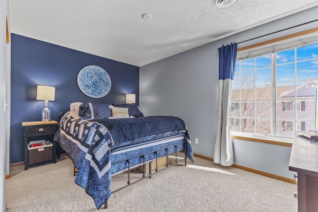 bedroom with baseboards, a textured ceiling, and carpet flooring