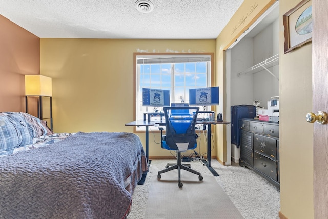 carpeted bedroom featuring visible vents, baseboards, and a textured ceiling