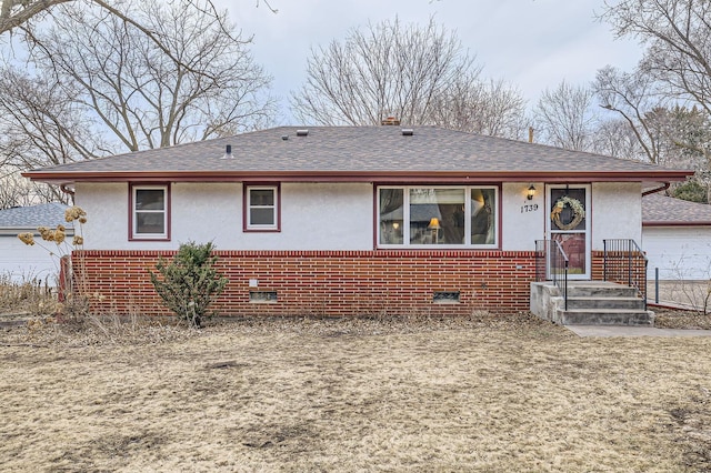 single story home featuring crawl space, brick siding, and roof with shingles