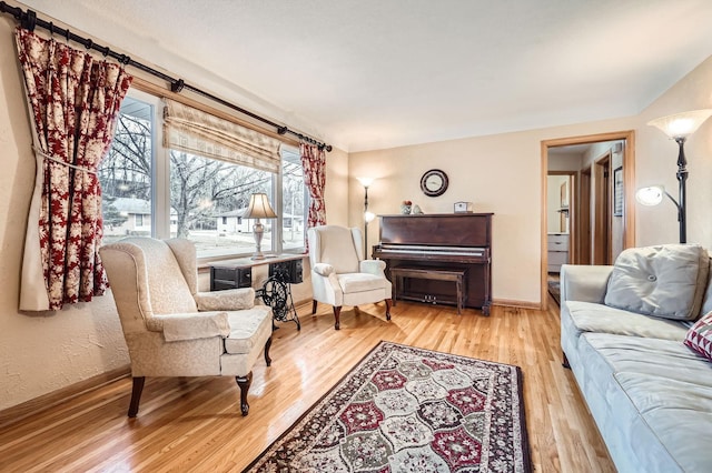 living room featuring baseboards and wood finished floors