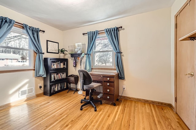 office featuring baseboards, visible vents, and light wood-type flooring