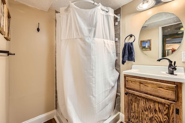 full bathroom with vanity, a textured ceiling, and a shower with shower curtain