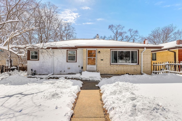 single story home with brick siding and fence