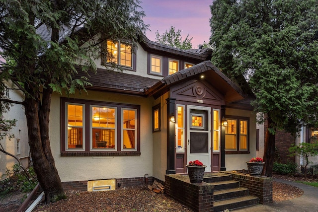1286 Fairmount Ave, Saint Paul, MN 55105 - back of house at dusk featuring stucco siding