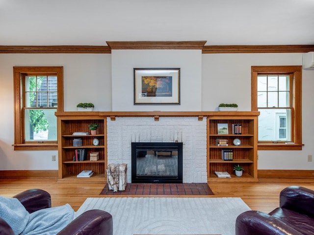 1286 Fairmount Ave, Saint Paul, MN 55105 - living area with wood finished floors, baseboards, ornamental molding, a wall mounted AC, and a brick fireplace