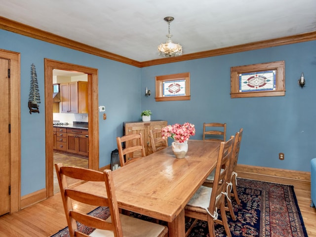 1286 Fairmount Ave, Saint Paul, MN 55105 - dining area featuring crown molding, light wood-type flooring, and baseboards