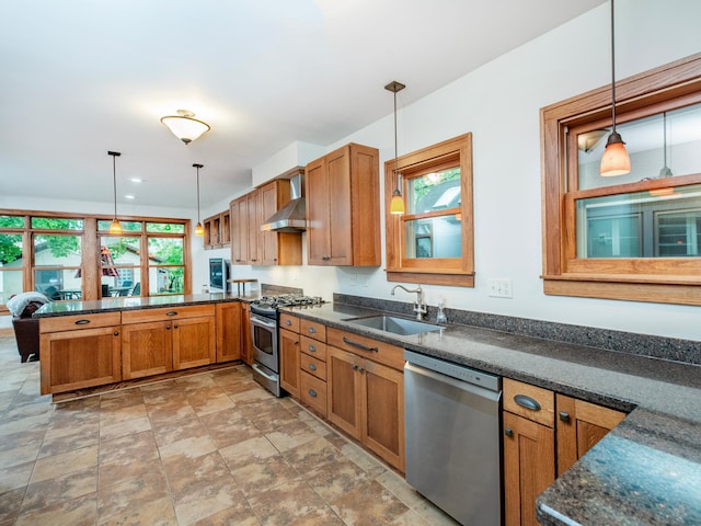 1286 Fairmount Ave, Saint Paul, MN 55105 - kitchen featuring appliances with stainless steel finishes, a sink, wall chimney exhaust hood, a peninsula, and brown cabinetry