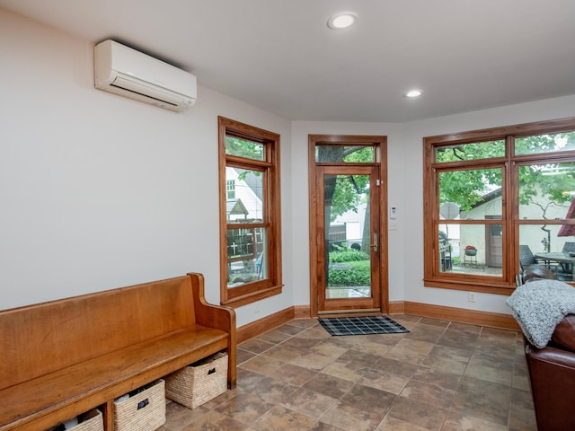 1286 Fairmount Ave, Saint Paul, MN 55105 - doorway featuring a wall unit AC, baseboards, stone finish flooring, and recessed lighting