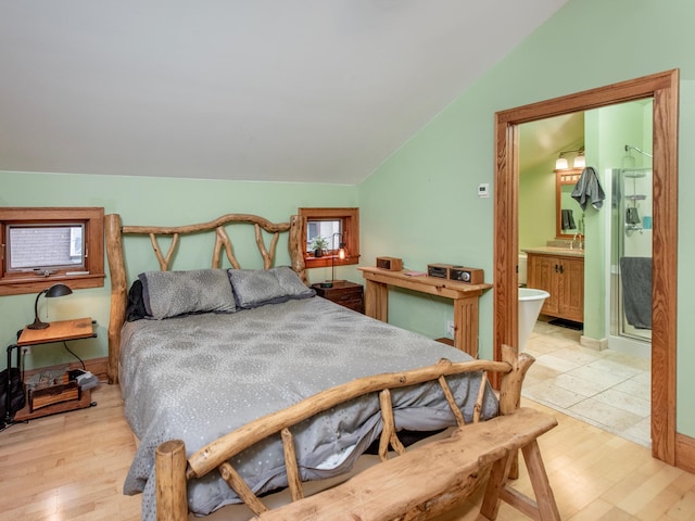 1286 Fairmount Ave, Saint Paul, MN 55105 - bedroom with vaulted ceiling, light wood-style floors, and ensuite bath