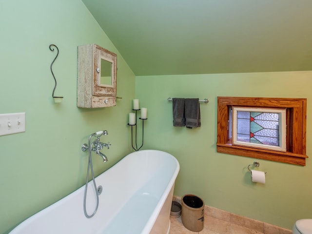 1286 Fairmount Ave, Saint Paul, MN 55105 - full bathroom featuring a soaking tub, baseboards, vaulted ceiling, and tile patterned flooring