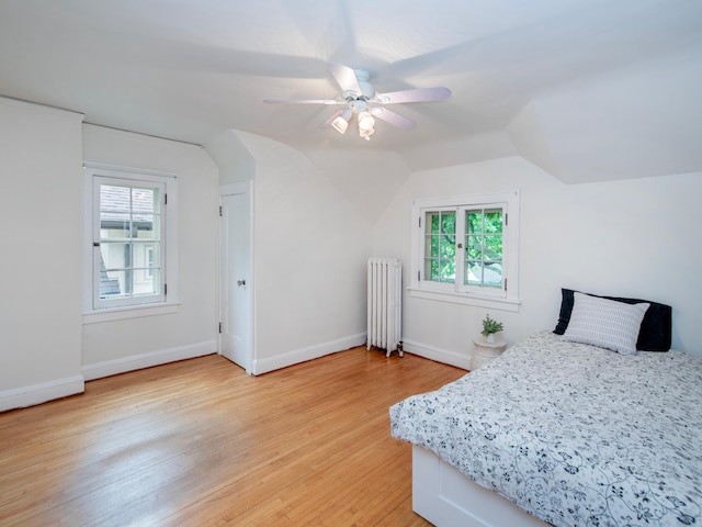 1286 Fairmount Ave, Saint Paul, MN 55105 - bedroom with radiator heating unit, vaulted ceiling, light wood-style floors, multiple windows, and baseboards