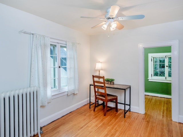 1286 Fairmount Ave, Saint Paul, MN 55105 - home office with radiator heating unit, hardwood / wood-style flooring, baseboards, and ceiling fan
