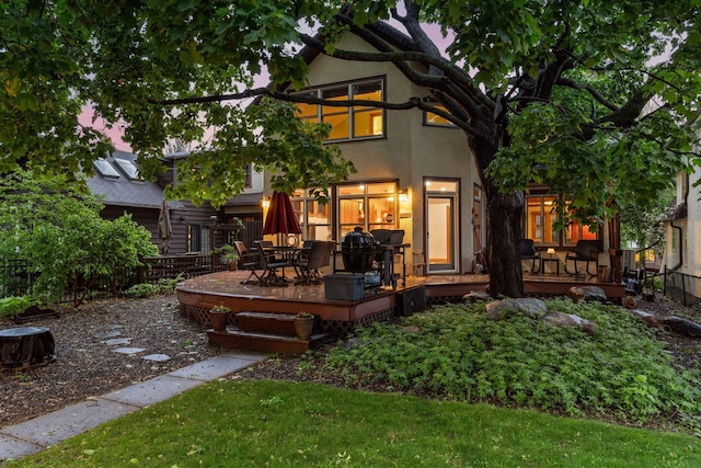 1286 Fairmount Ave, Saint Paul, MN 55105 - rear view of house with a wooden deck, stucco siding, and outdoor dining space