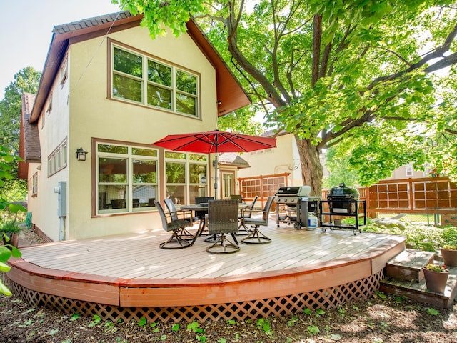 1286 Fairmount Ave, Saint Paul, MN 55105 - rear view of property with outdoor dining space, stucco siding, and a wooden deck