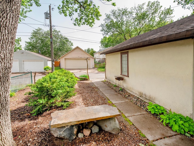 1286 Fairmount Ave, Saint Paul, MN 55105 - view of yard with a detached garage and an outdoor structure