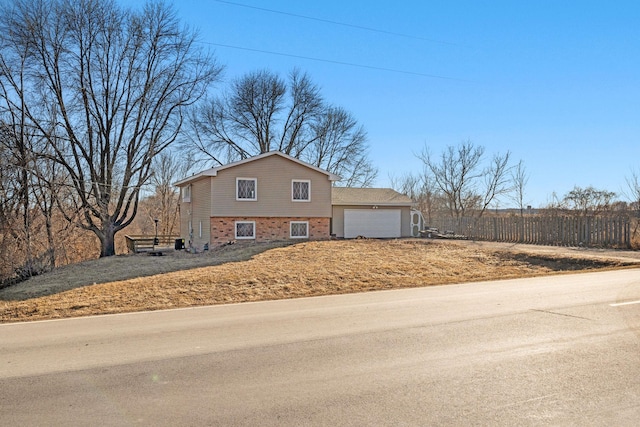 view of front of property featuring brick siding and an attached garage