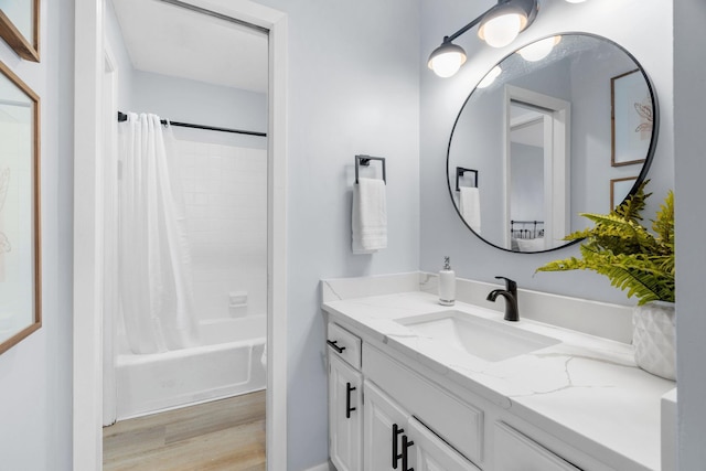 bathroom featuring shower / bath combination with curtain, wood finished floors, and vanity