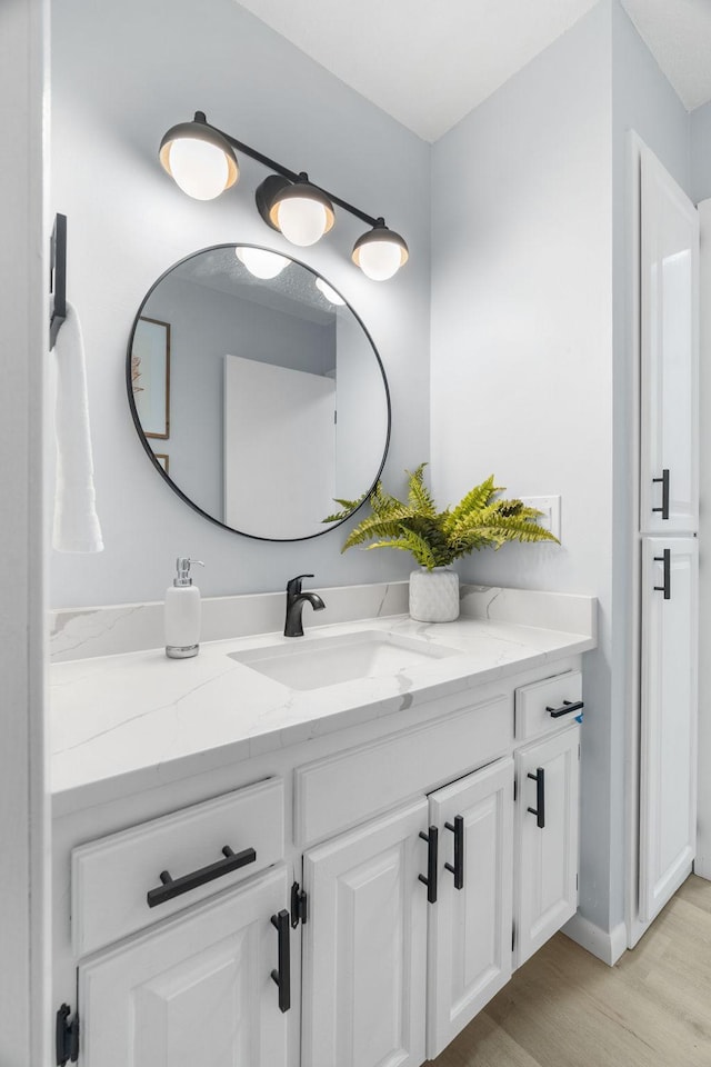 bathroom featuring vanity and wood finished floors