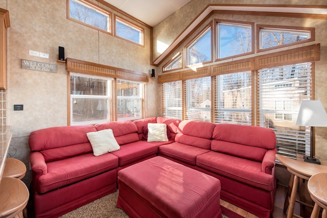 living area with a towering ceiling