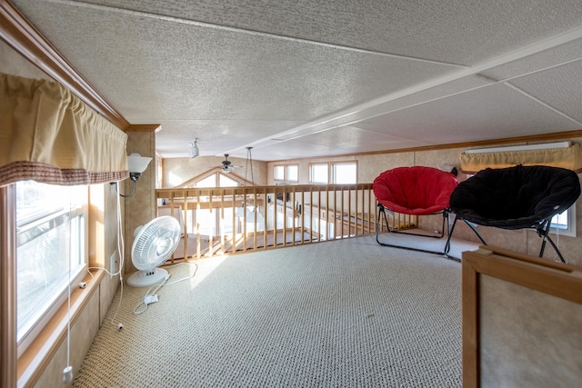 unfurnished room featuring carpet flooring, a textured ceiling, and ceiling fan