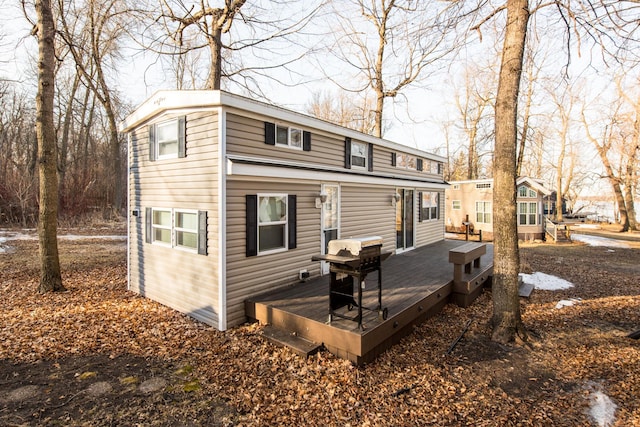 back of property featuring a deck