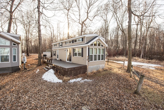 back of property featuring a wooden deck