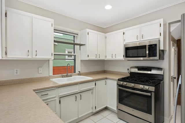 kitchen with white cabinetry, light countertops, appliances with stainless steel finishes, and a sink