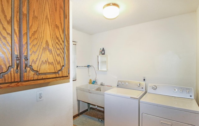 laundry room with cabinet space, baseboards, and separate washer and dryer