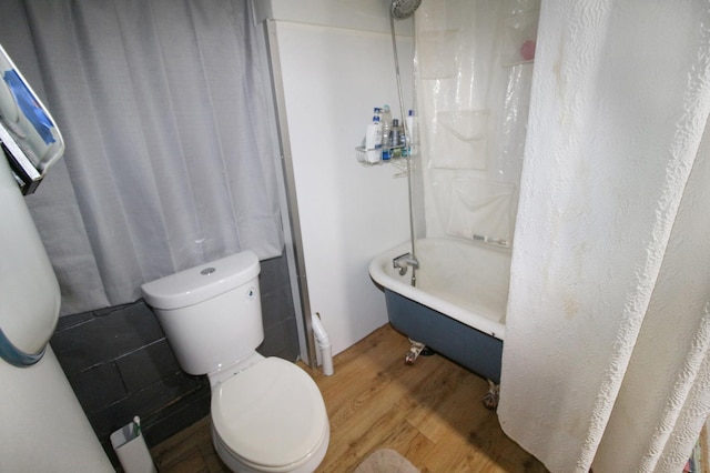 full bathroom with shower / bath combination, toilet, and wood finished floors