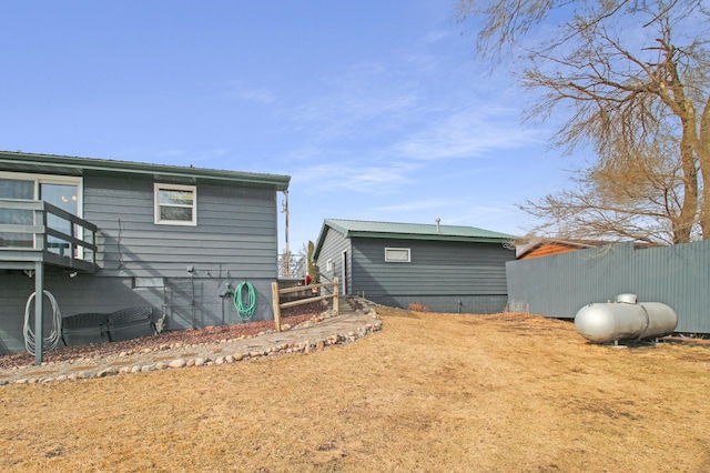 rear view of property featuring fence