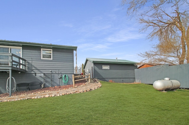 back of house featuring a lawn and fence